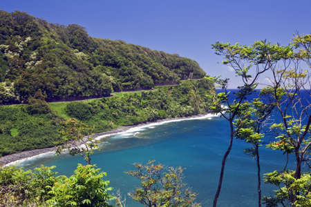 The Hana Highway clings to the coast in a tropical rain forest の写真素材