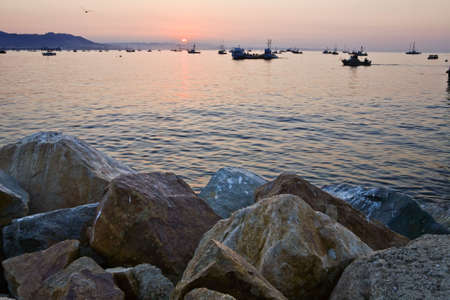 Sun rises over an armada of fishing boats in Avila Harbor, CAの写真素材