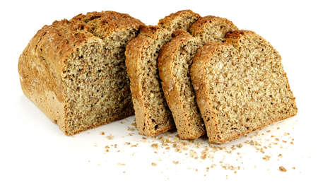 a loaf of bread with three slices and bread crumbs on a white table