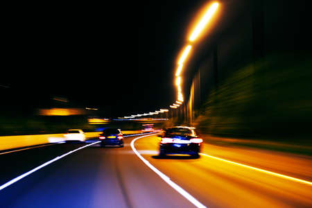 An impression style of picture of moving traffic on a motor way at nightの写真素材