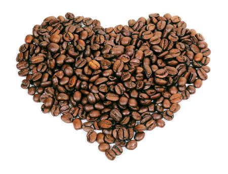 A heart shape created with coffee beans on a white の写真素材