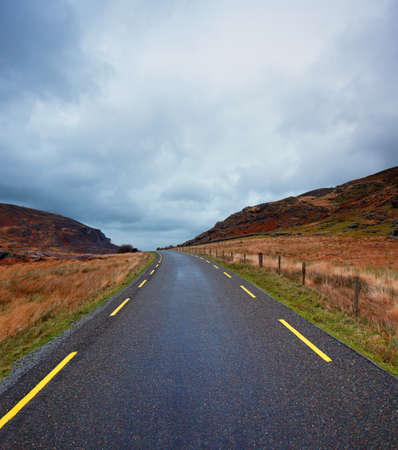 A narrow curvy road in the scenic Gap of Dunloe of County Kerry, Irelandの写真素材