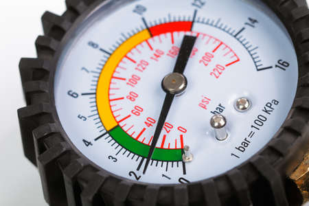 A compressor pressure gauge on a white background