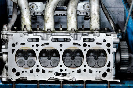 Worn out engine head with four valves per cylinderの写真素材