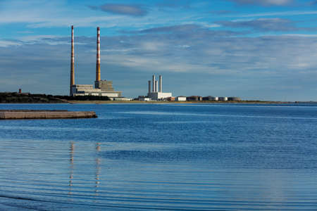 Poolbeg chimneys of the Ringsend area of Dublin, Ireland as seen from the Sandymount Beachの写真素材