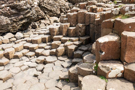 The Giants Causeway in County Antrim of Northern Ireland is declared a World Heritage Site by UNESCO containing about 40000 interlocking basalt columns being a result of an ancient volcanic eruptionの写真素材