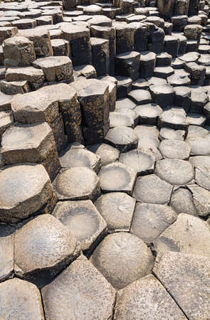 The Giants Causeway in County Antrim of Northern Ireland is declared a World Heritage Site by UNESCO containing about 40000 interlocking basalt columns being a result of an ancient volcanic eruptionの写真素材