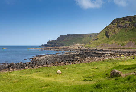 Thousands of tourists visiting Giant's Causeway in County Antrim of Northern Ireland, a World Heritage Site by UNESCO containing about 40000 interlocking basalt columns from ancient volcanic eruptionのeditorial素材