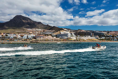 Motorboating off the west coast of Tenerife, one of many leisure activities offered to tourists in the Canaries. The deep-blue waters contrasted by a vibrant scenery make for a relaxing setting.のeditorial素材