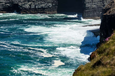 Cliffs of Loop Head, Kilbaha, Co. Clare, Ireland. Unique geological rock formations has formed over millions of years due to water erosion by the crashing waves of the North Atlantic Ocean.の写真素材