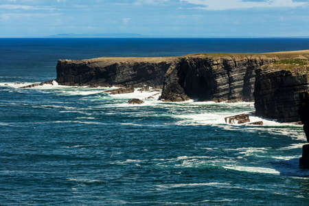 Cliffs of Loop Head, Kilbaha, Co. Clare, Ireland. Unique geological rock formations has formed over millions of years due to water erosion by the crashing waves of the North Atlantic Ocean.の写真素材