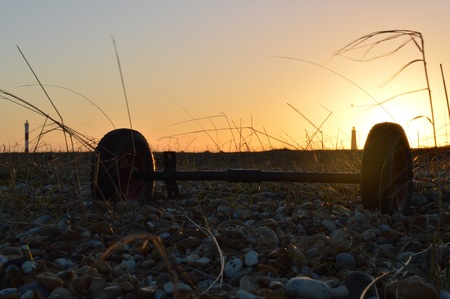 Disconnected Wheels Rest At Sunsetの写真素材