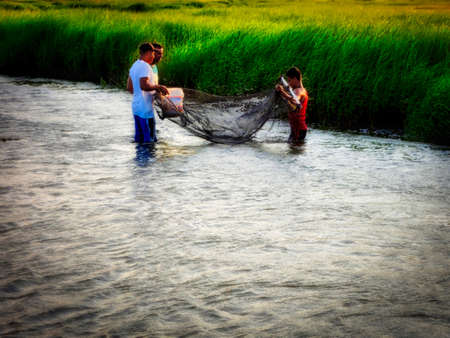 Fishermen In Waterの写真素材