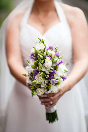 Beautiful wedding bouquet in hands of the brideの写真素材