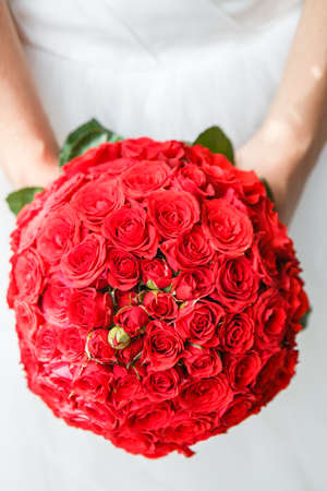 bouquet of red roses in bride's handsの写真素材