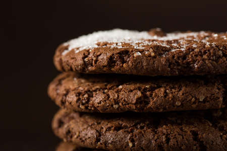 Stack of Chocolate chip cookies on brown background. Stacked chocolate chip cookies shot with selective focus.の写真素材