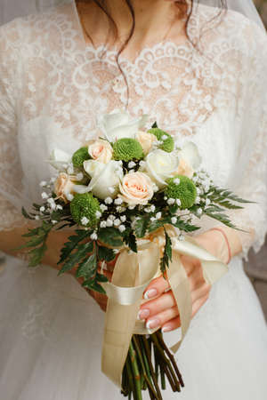 Beautiful wedding bouquet in hands of the brideの写真素材