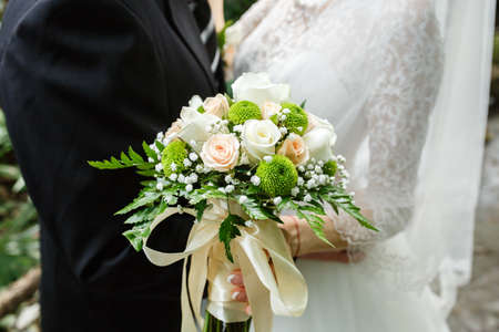 Beautiful wedding bouquet in hands of the brideの写真素材