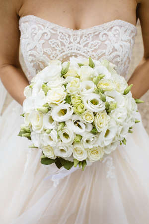 Beautiful wedding bouquet in hands of the brideの写真素材