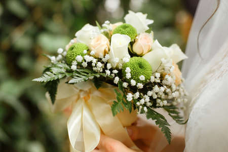 Beautiful wedding bouquet in hands of the brideの写真素材
