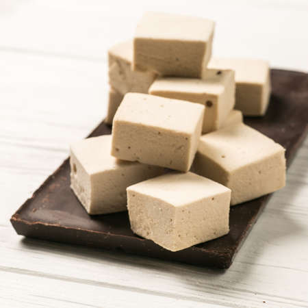 Marshmallow and chocolate tile on a white backgroundの写真素材