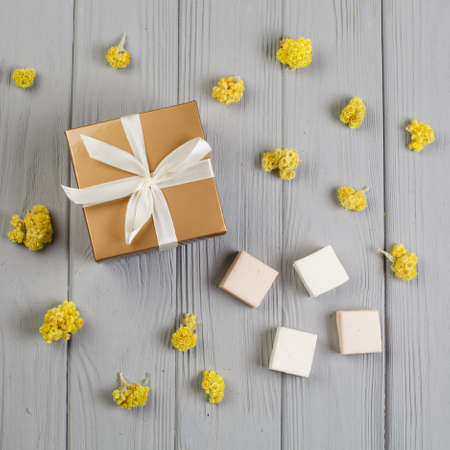 Assorted marshmallow on grey wood table with gift box for eight marchの写真素材