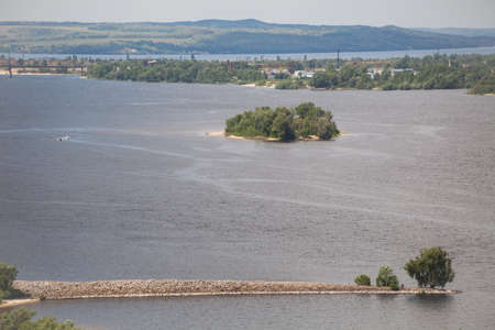 Panoramic view from mountain Tarasova in Kanev, Cherkassy region, on small island and hydroelectric dam on broad Dnieper in quiet evening summertime sunsetの写真素材