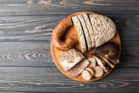 rye bread, sausage, smoked bacon on a wooden platter