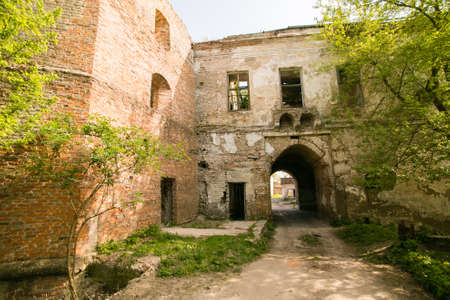 Ruins of the old Klevan castle. Ruined wall with windows against the blue sky. Courtyard. Rivne region. Ukraineの写真素材