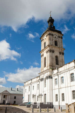 Ancient monastery of Discalced Carmelites, cathedral and fortress wall on background of blue cloudy sky. City Berdychiv, Ukraine. Tourist attraction. Place of visit by Pope John Paul IIのeditorial素材