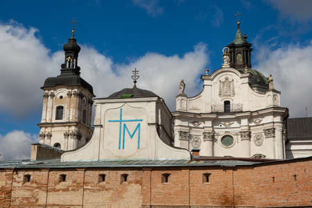 Ancient monastery of Discalced Carmelites, cathedral and fortress wall on background of blue cloudy sky. City Berdychiv, Ukraine. Tourist attraction. Place of visit by Pope John Paul IIのeditorial素材