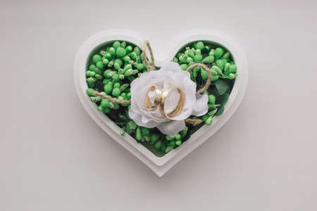 Wedding ring on a stand of plants in rustic style, botanist
