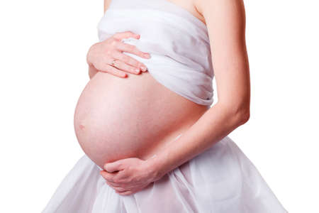 Pregnant woman holding her belly armsの写真素材