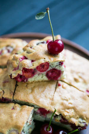 Homemade cherry pie on a plate and wood background closeup