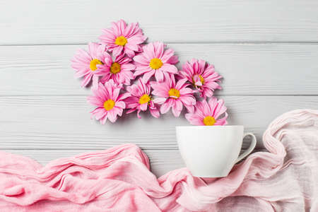 pink gerbera flowers fly out of a cup of teaの写真素材