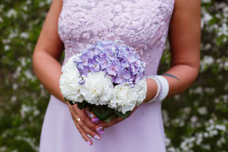 Beautiful wedding bouquet in hands of the brideの写真素材