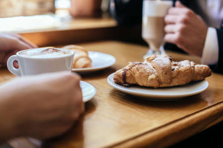 French breakfast concept, drinking coffee with croissant on wooden table.の写真素材