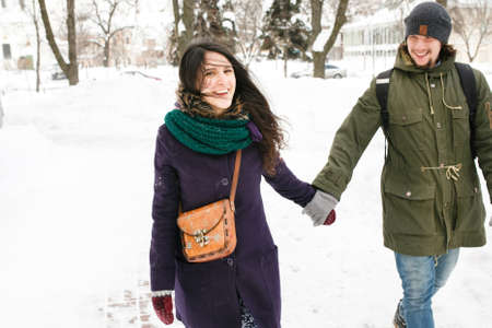 Happy Young in love couple in winter park having fun.の写真素材
