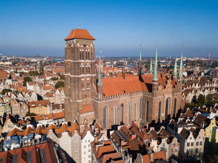 Aerial view from drone on St. Mary Cathedral and City Hall spire clock tower in Gdansk, Poland