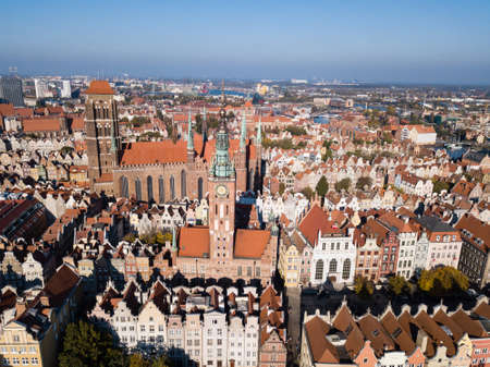 Aerial view from drone on St. Mary Cathedral and City Hall spire clock tower in Gdansk, Poland