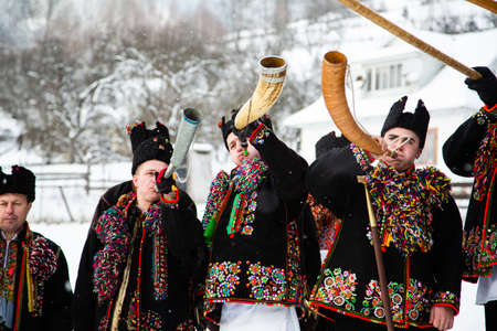 Kryvorivnia, Ukraine - January 7, 2019: Famous hutzulian Koliadnyky of Kryvorivnia singing Christmas carols and marching around ancient wooden church. Old winter traditions of Carpathian mountains.のeditorial素材