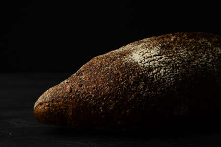 Rye bread ciabatta on a black wooden backgroundの写真素材