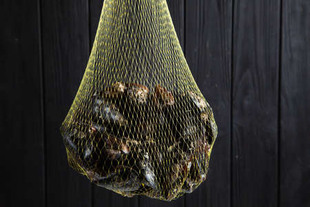 Fresh raw mussels in a grid on black wood backgroundの写真素材