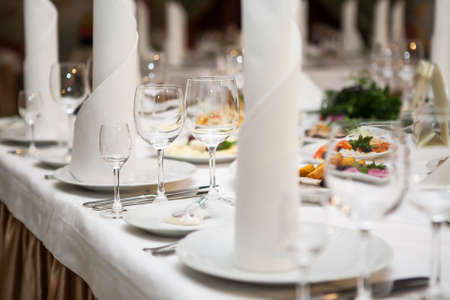 Served for banquet restaurant table with dishes, snack, wine and water glasses, european foodの写真素材