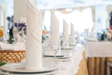 Served for banquet restaurant table with dishes, snack, wine and water glasses, european foodの写真素材