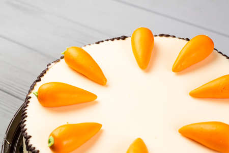 homemade cake with carrot decor on gray wooden tableの写真素材