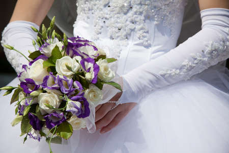 Beautiful wedding bouquet in hands of the brideの写真素材