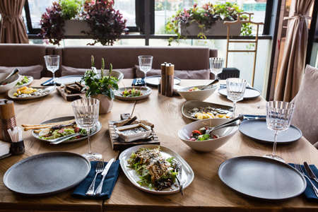 Served for banquet restaurant table with dishes, snack, wine and water glasses, european food