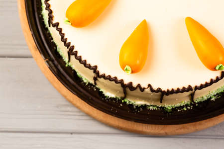 homemade cake with carrot decor on gray wooden table