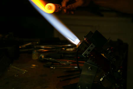 Process glass blowing manufacturing . Fire heats glass blank with glass-blowing burner. Handmade...